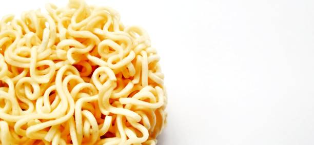 istock Uncooked instant noodles with negative space isolated on the gray white studio background. 1404959795