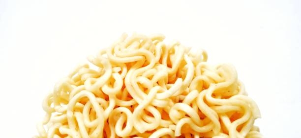 istock Uncooked instant noodles with negative space isolated on the gray white studio background. 1404959812