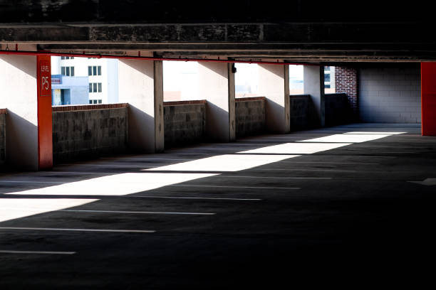istock inside of a dark parking garage with light shining from outside 1404961543