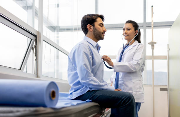 Female doctor examining a patient at her office stock photo
