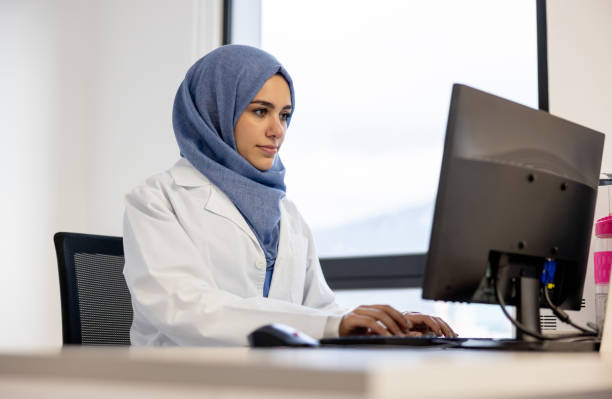 istock Muslim doctor working in her office 1404962373