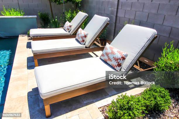 Three Adjustable Lounge Chairs By Swimming Pool Stock Photo - Download Image Now - Lounge Chair, Cushion, Patio
