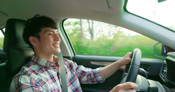 istock man drives electric car 1404968374