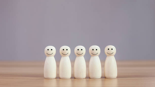istock Happy wood person model a smiley on table background. 1404970221
