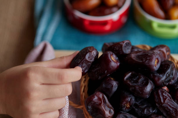 istock Children hand picking dried dates 1404975958