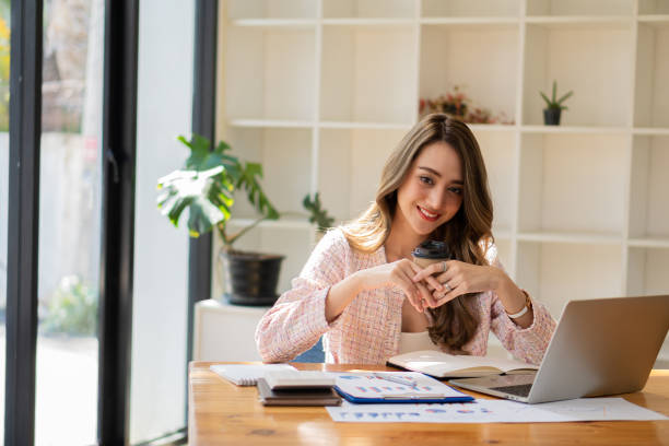 istock young businesswoman looking at financial data from laptop She is analyzing, calculating, examining the financial documents of a start-up woman. financial management concept 1404979661