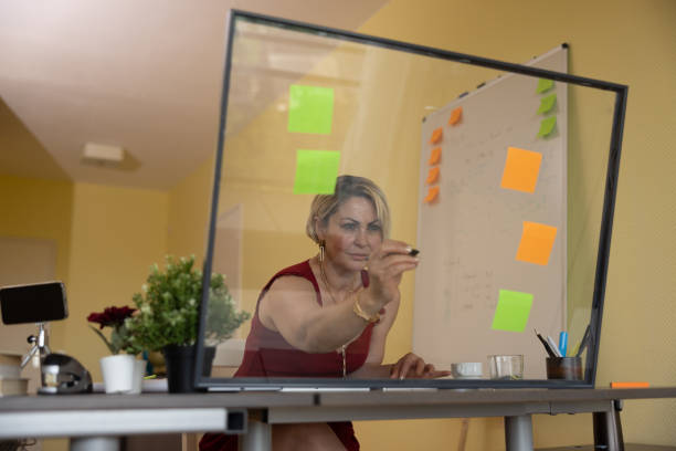 istock Woman using technology at home and in the office. Seen through laptop/computer screen 1404981070