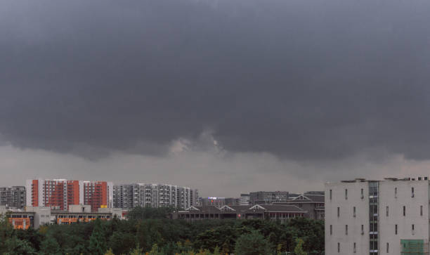 istock The sky is thick with clouds. Below the sky are buildings and trees 1404981806