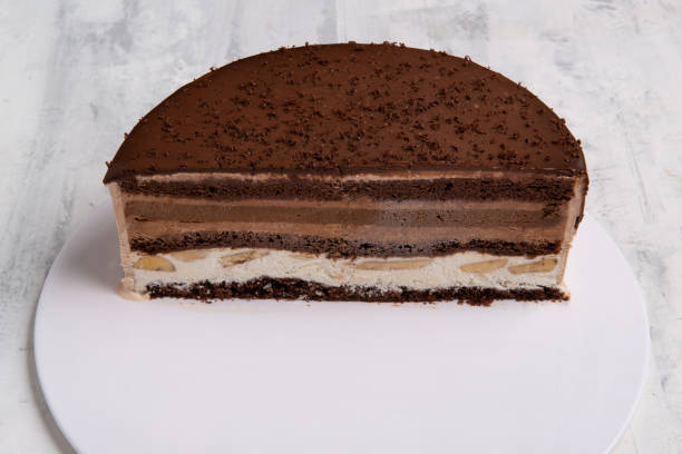 istock Close up shot of half chocolate cake slice on a white plate. 1404982140