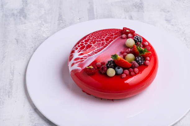 istock Angle shot of a mirror glaze cake decorated with berries. 1404983042