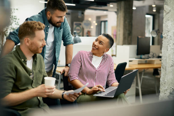 istock Young happy entrepreneurs cooperating while working on laptop in the office. 1404987353