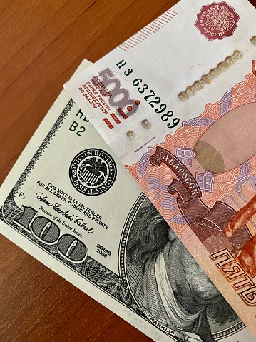 100 dollars and 5000 roubles banknotes