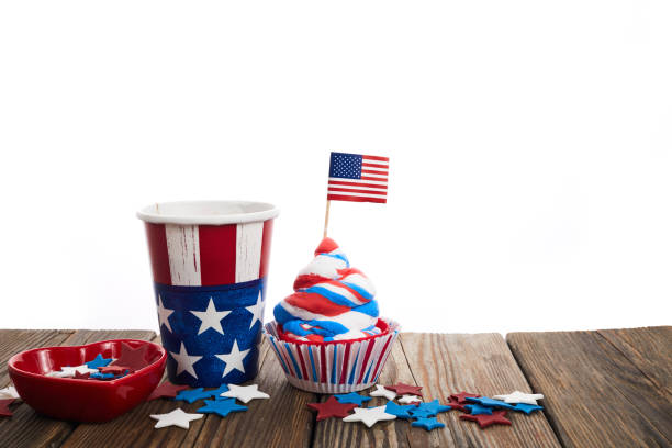 istock American independence day, celebration and holidays concept - cupcake in disposable tableware and stars. 1404990778