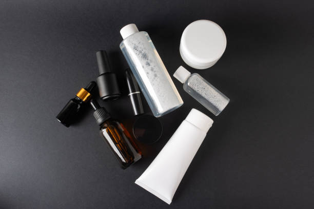 istock Set of white and black cosmetics, from above on a black background 1404994292