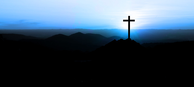 Wooden cross at sunset