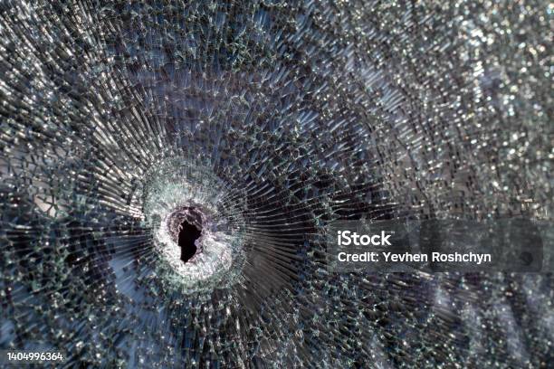 Holes On The Windshield Of The Car It Was Shot From A Firearm Bullet Holes Smash Car Windshield Broken And Damaged Car The Bullet Made A Cracked Hole In The Glass Stock Photo - Download Image Now
