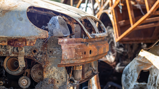 Wrecked vehicles seen in a car junkyard. Rows of destroyed cars in accidents used for recycling. Galicia, Spain.