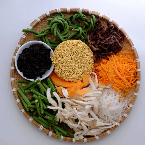 Prepare and mix to make vegan instant noodles with vegetables, raw material as string bean, mushroom, carrot, simple ingredient for vegetarian breakfast that rich fiber