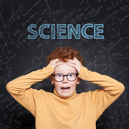 Tired child student screaming against science background