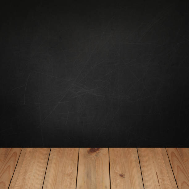 istock Wooden table top with concrete blackboard wall background for product placement 1405000677