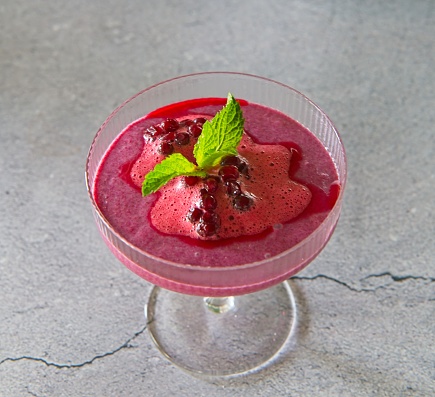 Finnish style whipped lingonberry dessert seasoned with vanilla sugar and garnished with mint leaf.