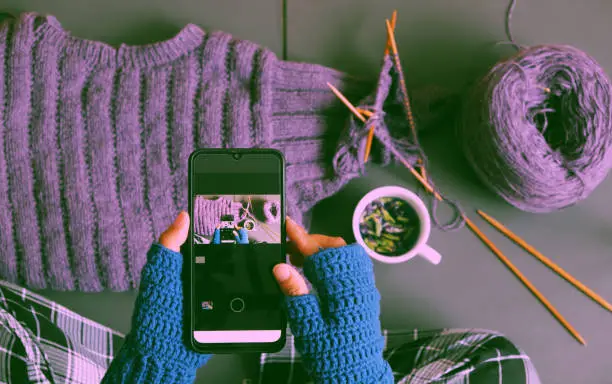 Photo of woman hand wear blue mitten crochet, knit violet sweater for gif