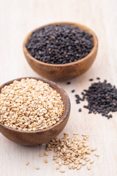 istock White sesame and black sesame seed on wooden bowl. 1405008011