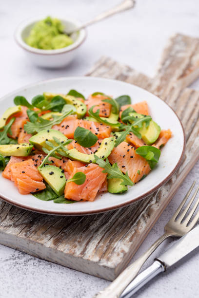 istock Salmon salad with avocado,  for keto and low carb diet. Rusty background, top view, copy space. 1405008074