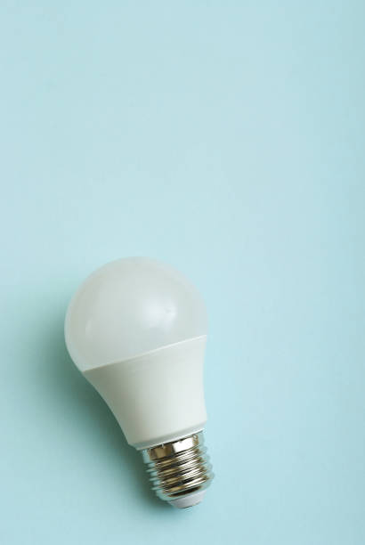 istock White economy light bulb on blue background with free copy paste space for text. 1405009246