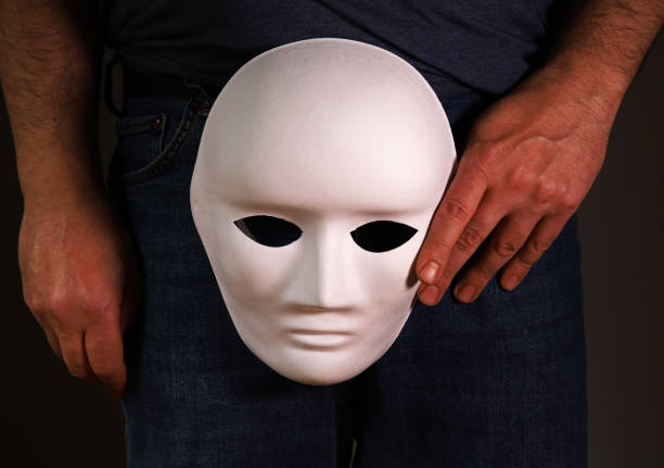 istock person in jeans with white theatrical mask 1405011161
