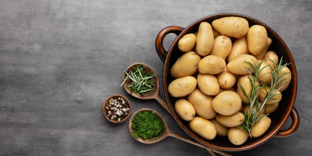 istock Raw small potatoes in a cast iron skillet on a beton background. 1405012276