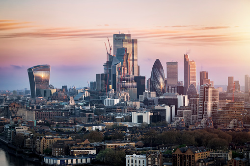 Sunrise view of the City of London with the skyscrapers reflecting the soft sunlight, England