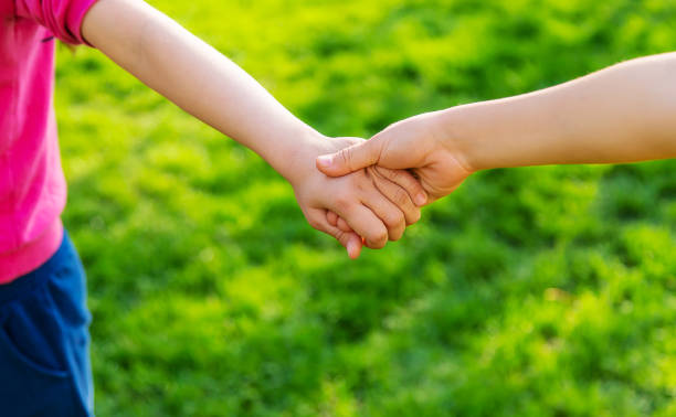 istock Children walk together holding hands. Selective focus. 1405015175