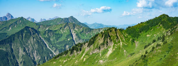 Kleinwalsertal mountains landscape panorama background - Mountain panorama in summer with blue sky and clouds Kleinwalsertal mountains landscape panorama background - Mountain panorama in summer with blue sky and clouds kleinwalsertal stock pictures, royalty-free photos & images