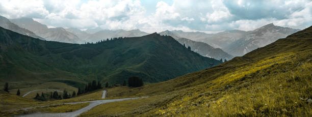 istock Kleinwalsertal mountains landscape panorama background - Mountain panorama in summer with blue sky and clouds 1405016032