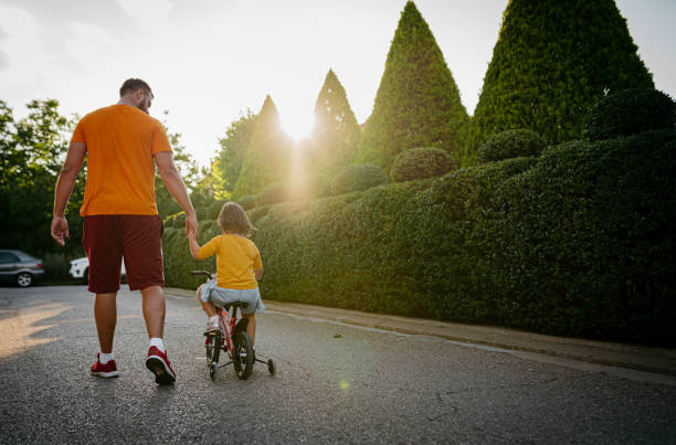 istock Dad and daughter ride a bike 1405016742