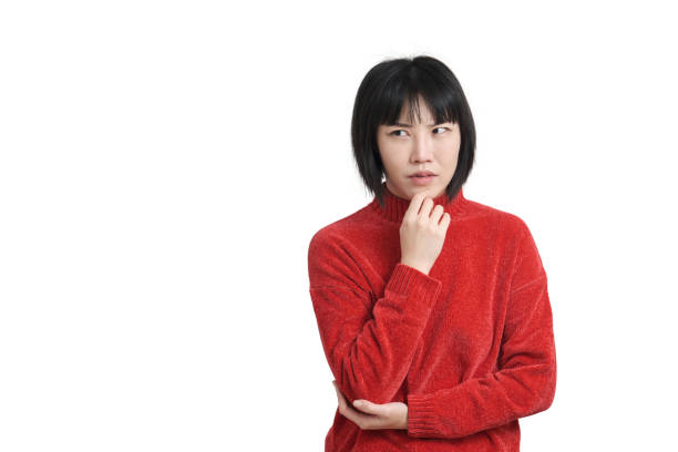 istock Young asian woman touching her chin with pensive expression, isolated. 1405017755
