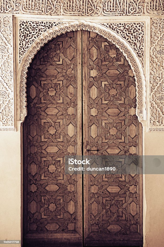 Traditional Moorish architecture, Ornate wooden door, Toned black and white Door Stock Photo