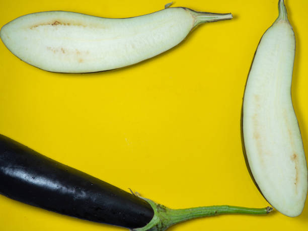 istock Sliced  eggplant on a yellow background. Vegetables on the table. Beautiful eggplant. Common vegetable. Cooking. 1405018082