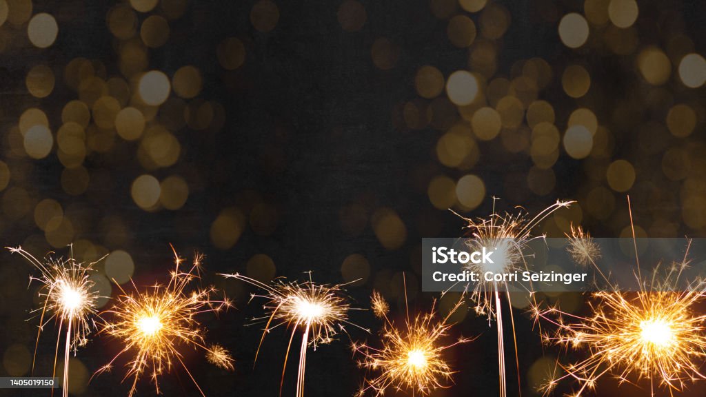 Silvester 2023 New Year New Year's Eve Party background - sparklers fireworks and bokeh light on black night texture, with space for text New Year Stock Photo