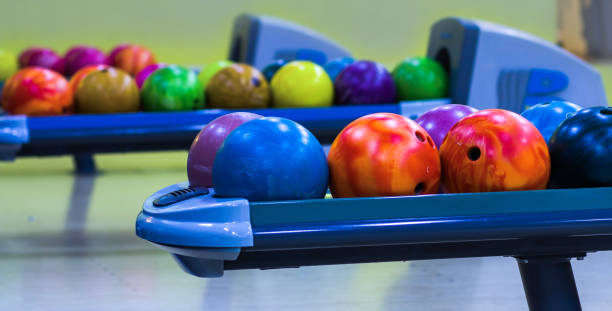 istock bowling balls in the ball return machine, background 1405019215