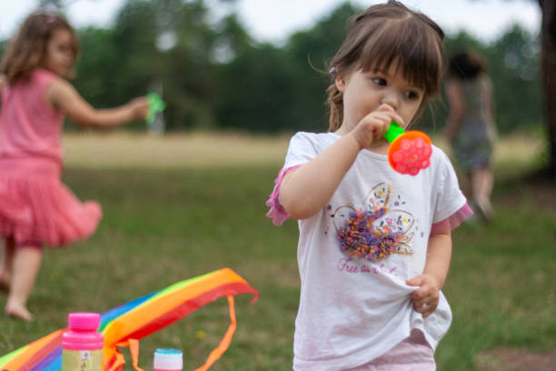 istock The young girl is blowing bubbles. 1405020050