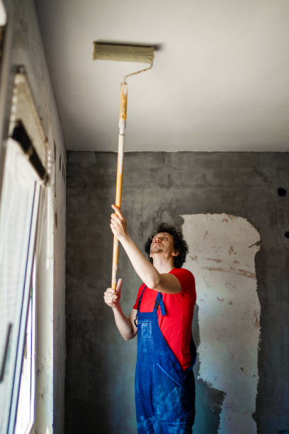 istock Construction worker painting apartment walls 1405020387