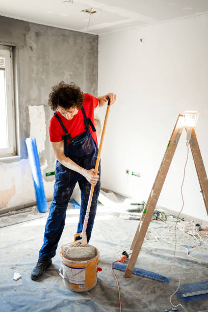 istock Construction worker painting apartment walls 1405020390