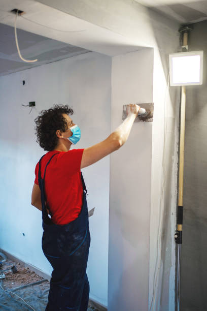 istock Construction worker painting apartment walls 1405020404