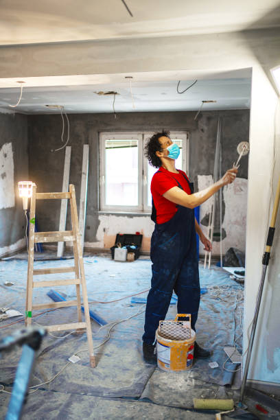 istock Construction worker painting apartment walls 1405020407