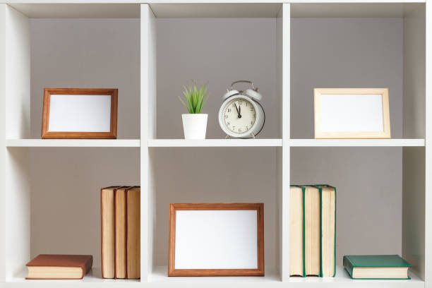 istock White shelves photo frames books decor. Home interior. 1405021494