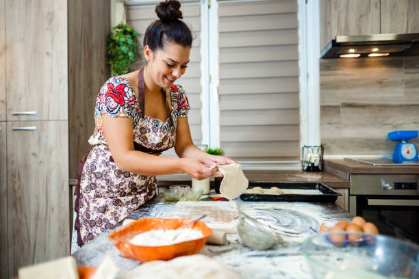 istock Woman kneading pastry in the kitchen 1405023678