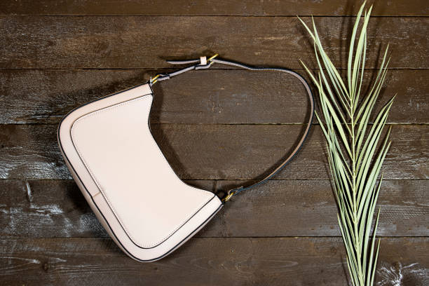 istock pink shoulder bag with palm leaf on wood table 1405026489