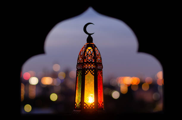 Lantern that have moon symbol on top with blurred focus of paper cut for mosque shape background. Lantern that have moon symbol on top with blurred focus of paper cut for mosque shape background. Ramadan Kareem and Islamic new year concept. muharram stock pictures, royalty-free photos & images